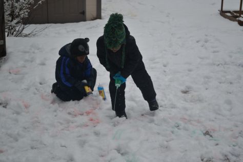 boys painting in snow